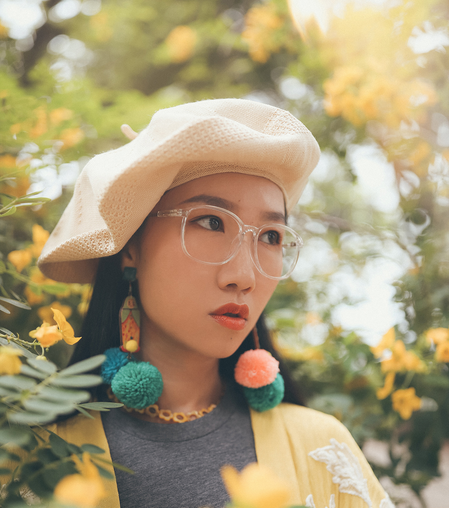 Woman wearing colourful fluffy earrings