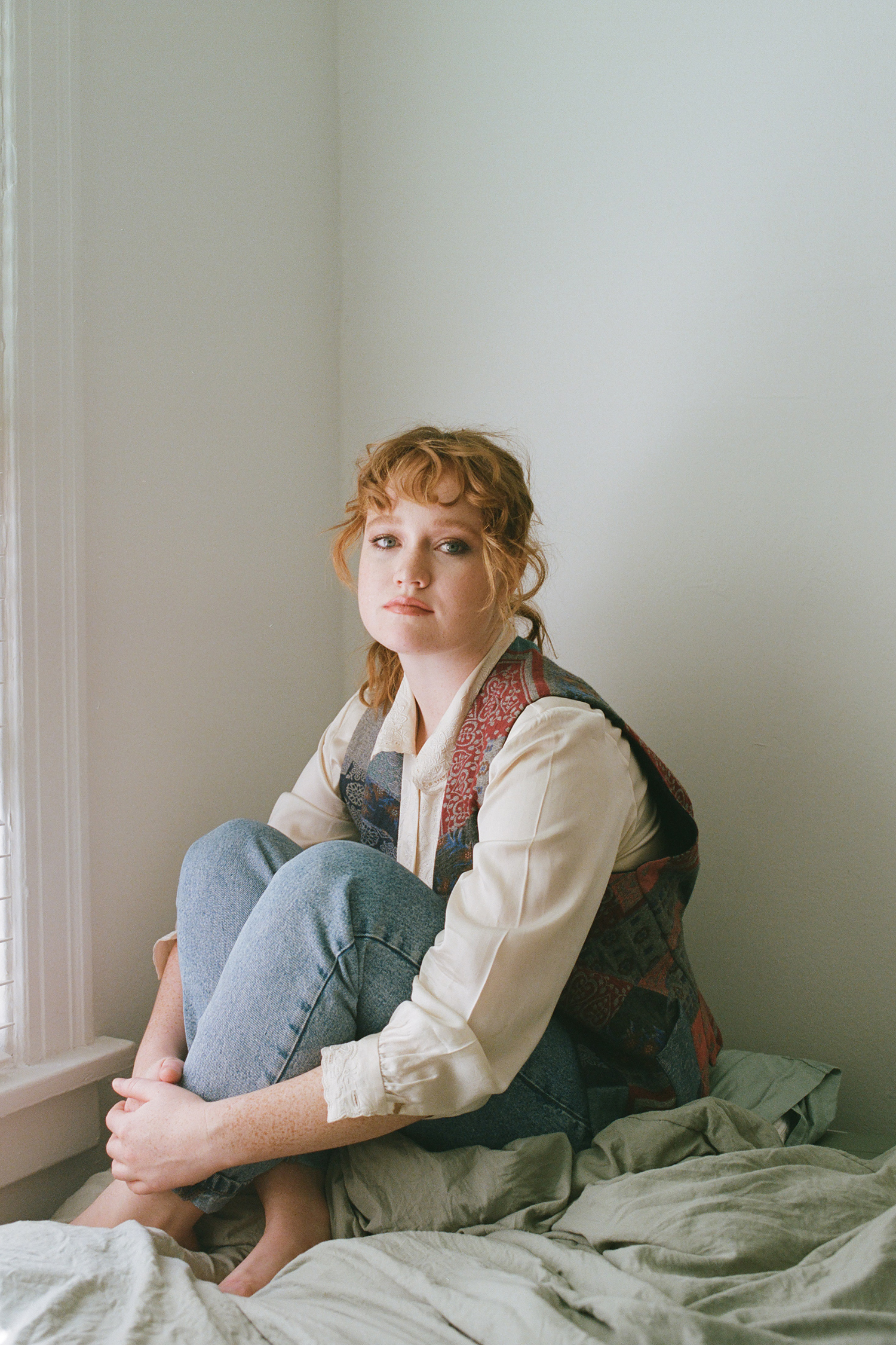 Woman sitting on bed