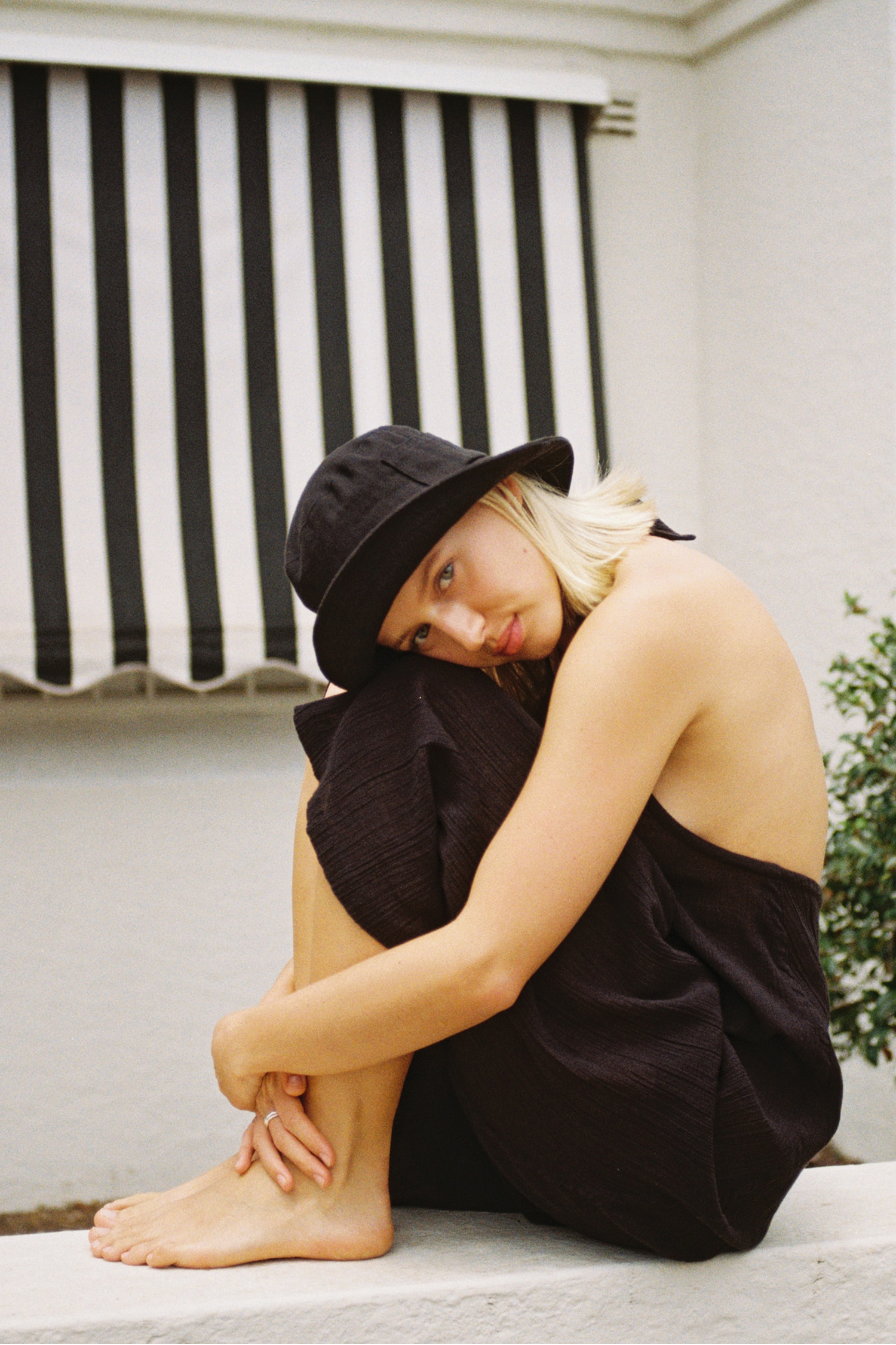 Woman wearing black dress and hat