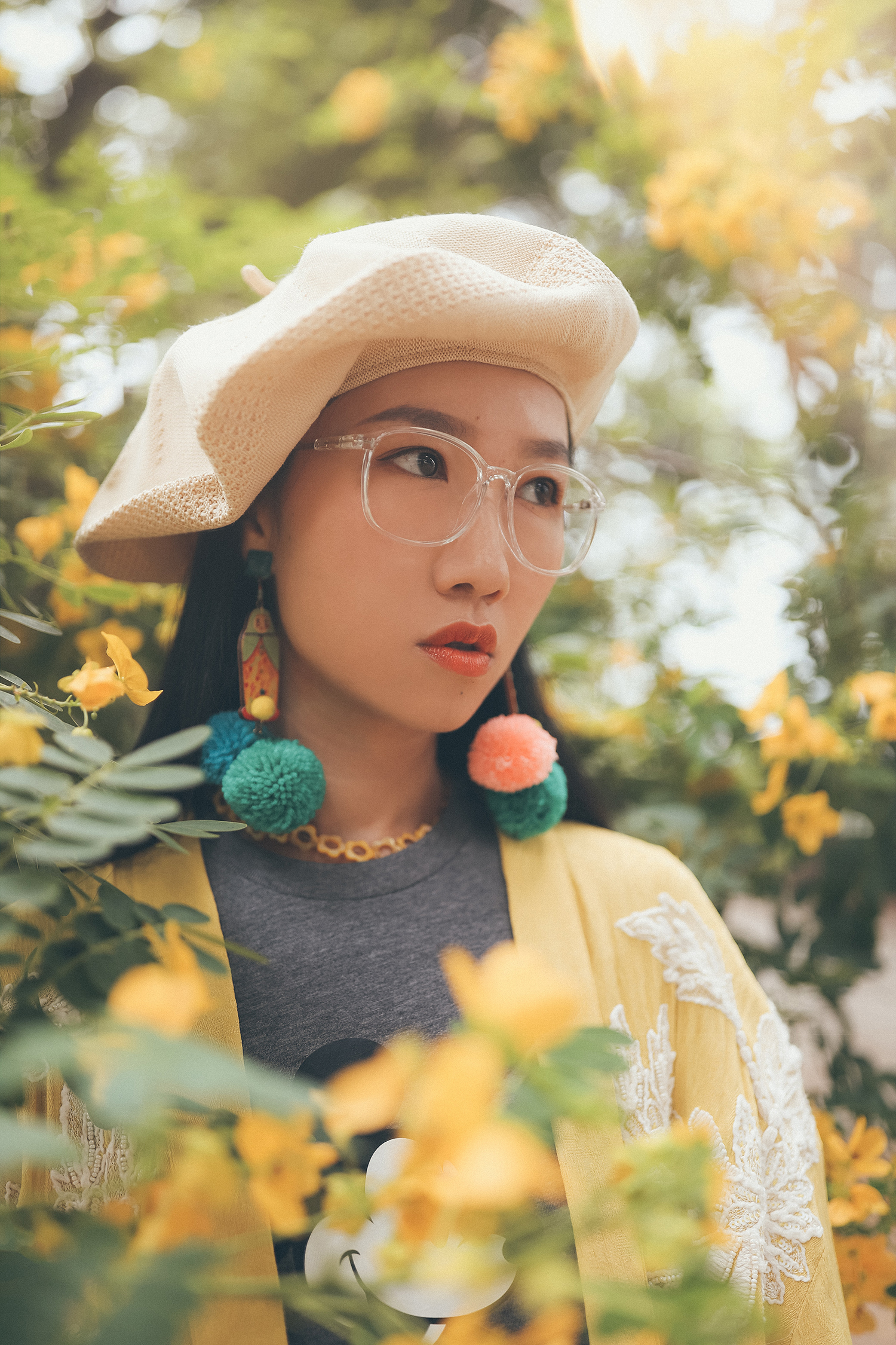 Woman wearing colourful fluffy earrings