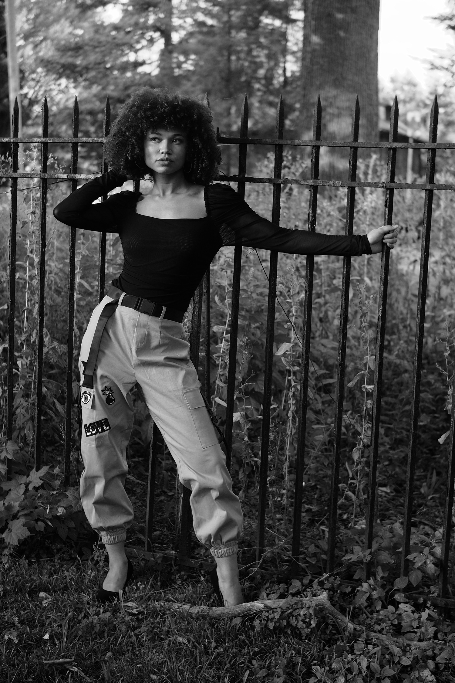 Woman posing in front of a fence